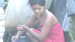 Young sexy Indian girl taking open air shower recorded